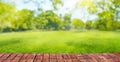 green grass blurred background with sun rays in park meadow and wooden floor Royalty Free Stock Photo