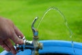 Drinking Fountain with Water Flowing to Drink Hand Turning Valve Wet Royalty Free Stock Photo