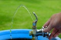 Drinking Fountain with Water Flowing to Drink Hand Turning Valve Wet Royalty Free Stock Photo