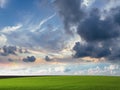 Green Grass Field Blue white clouds sky and rainbow nature summer landscape background Royalty Free Stock Photo