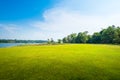 Green grass field with lake in public park Royalty Free Stock Photo