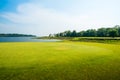 Green grass field with lake in public park Royalty Free Stock Photo