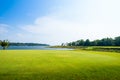 Green grass field with lake in public park Royalty Free Stock Photo