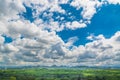 Green Grass Field Meadow with Wood and Mountain under Blue sky Royalty Free Stock Photo