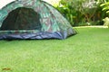 Green grass garden field with tent camping on lawn of campsite trip travel Royalty Free Stock Photo