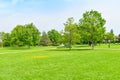 Green grass green trees in beautiful park white Cloud blue sky in noon. - Image Royalty Free Stock Photo