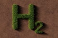 Green grass H2 hydrogen symbol over brown soil background, sustainable eco energy concept Royalty Free Stock Photo