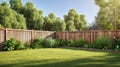 green grass lawn, flowers and wooden fence in summer backyard garden