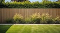 green grass lawn, plants and wooden fence in summer backyard garden