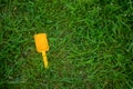 Child a spatula brighter color of lies on the grass Royalty Free Stock Photo