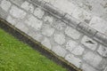 Green grass near an old stone wall in Fiera di Primiero, Pale di San Martino. Royalty Free Stock Photo