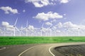 green grass and road and wind turbine farm