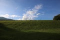 Green grass slope with cloudy blue sky in Angkaew CMU chiangmai thailand Royalty Free Stock Photo