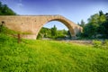 Green grass to ancient bridge