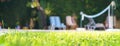 Green grass with water drops and green bokeh background on the yard with swimming pool and deck chairs for friends at garden party Royalty Free Stock Photo