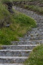 Stone stairs going up a green grassy bank in Dingle Ireland Royalty Free Stock Photo