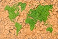 Green grass world map on cracked ground