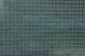 Green gray texture of metal mesh and a piece of cloth Royalty Free Stock Photo