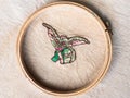 Green gremlin in wooden hoop embroidered by hand