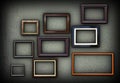 Green grungy wall full of frames Royalty Free Stock Photo