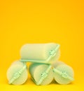 Green Hair Curlers on a yellow background