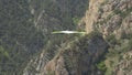 Green hangglider in the mountains