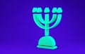 Green Hanukkah menorah icon isolated on blue background. Hanukkah traditional symbol. Holiday religion, jewish festival Royalty Free Stock Photo