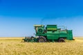 Green harvesting machine works in soybean field Royalty Free Stock Photo