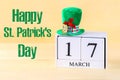 A green hat on a wooden table. St.Patrick's Day. A wooden calen