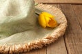 Green Hat with Yellow Tulip on Rustic Wood