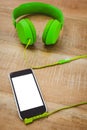 Green headphone with a back smartphone Royalty Free Stock Photo