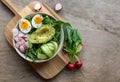 Green healthy salad with avocado and eggs.