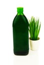 Green healthy superfood concept. Glass bottle of chlorophyll drink with fresh grass, wheat. Isolated on white background