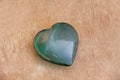 Green heart made of natural stone jade. A heart shaped stone lie