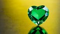 Green heart shaped diamond on yellow background and copy space on a side Royalty Free Stock Photo