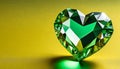 Green heart shaped diamond on yellow background and copy space on a side Royalty Free Stock Photo