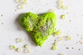 Green heart with shiny glitters made from slime