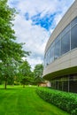 Green hedge and mowed lawn along round shaped wall of the round building wall Royalty Free Stock Photo