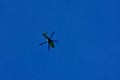 Green helicopter patrolling the sky