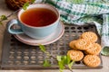Green herbal tea is served on a metal vintage antique retro tray with homemade cakes - round biscuit biscuits. on a wooden backgro Royalty Free Stock Photo