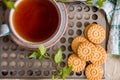 Green herbal tea is served on a metal vintage antique retro tray with homemade cakes - round biscuit biscuits. on a wooden backgro Royalty Free Stock Photo