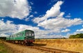 Green Heritage Railcar in Summer Countryside