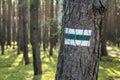 Green hiking trails marker on the tree