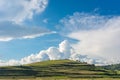 Green hill , blue sky with white fluffy clouds Royalty Free Stock Photo