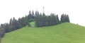 green hill with forest and signal antenna