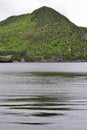 Green hill reflecting onto water of Bonne Bay at Norris Point Royalty Free Stock Photo