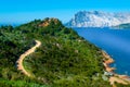 Green hill by the sea in Capo Coda Cavallo Royalty Free Stock Photo