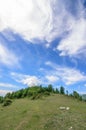 Green hill under blue sky with white clouds. Beautiful summer landscape. Nature of Georgia Royalty Free Stock Photo