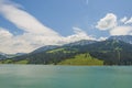 Green hills behind the turquoise lake in Longrin, Switzerland