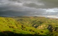 Green hills at sunset before rain Royalty Free Stock Photo